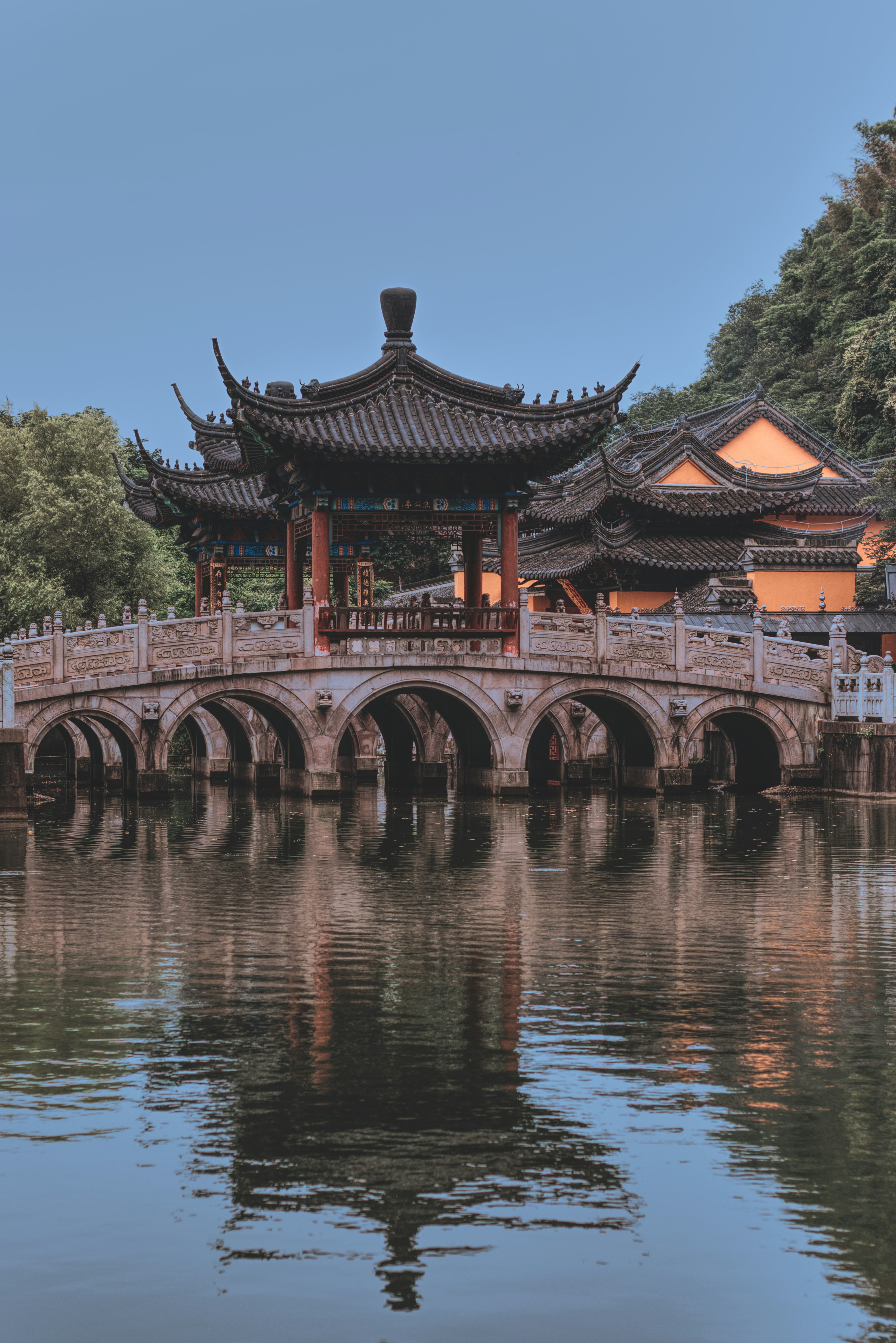 red and white temple near body of water during daytime